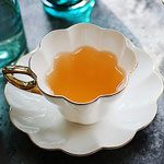 Stock white ceramic tea mugs and saucer Flower shape black tea cups with golden rim