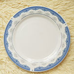 8-inch white ceramic flat plate with blue rim